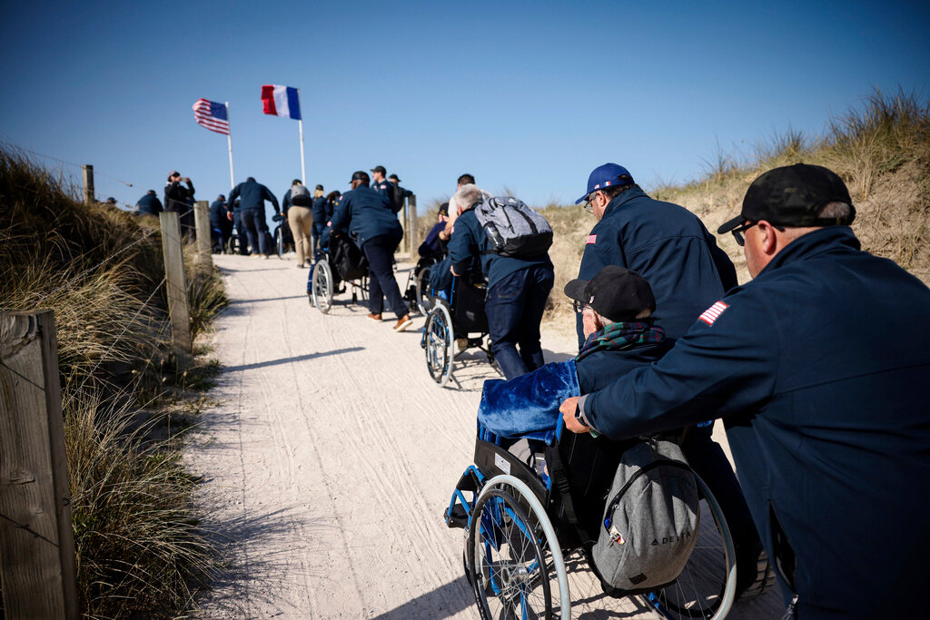 U.S. veterans arrive for the commemoration organized by the Best Defense Foundation at Utah Beach near Sainte-Marie-du-Mont, Normandy, France, Sunday, June 4, 2023, ahead of the D-Day Anniversary. (AP Photo/Thomas Padilla)