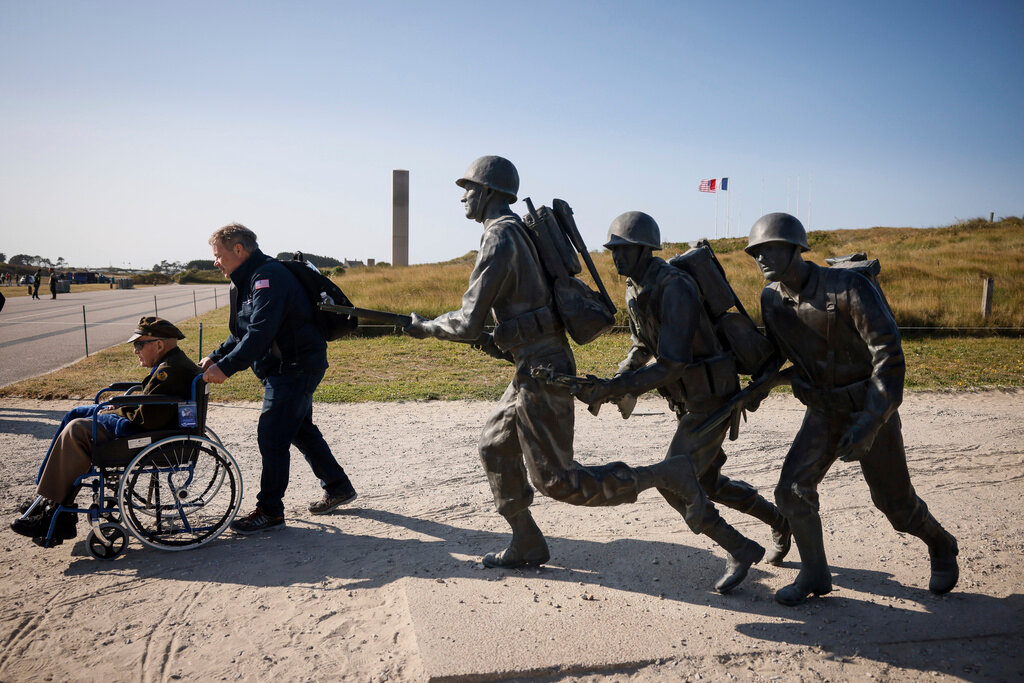 An American veteran is wheeled away after a commemoration organized by the Best Defense Foundation at Utah Beach near Sainte-Marie-du-Mont, Normandy, France, Sunday, June 4, 2023, ahead of the D-Day Anniversary. (AP Photo/Thomas Padilla)