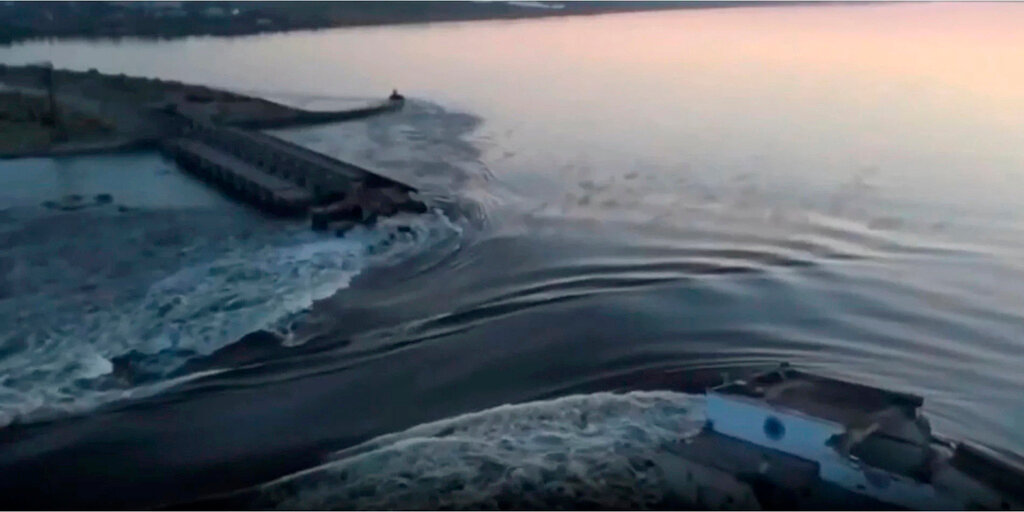 Water flows through a break in the Kakhovka dam in Kakhovka, Ukraine, Tuesday, June 6, 2023. (Ukrainian Presidential Office via AP)