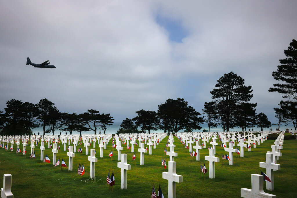 A plane flies over the American Cemetery in Colleville-sur-Mer, Normandy, Monday June 5, 2023. (AP Photo/Thomas Padilla)