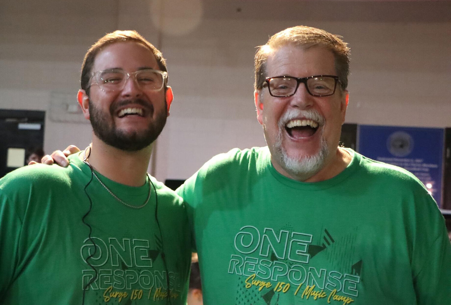 Noah Jackson, the band director at Brantley County High School and a former SURGE150 camper, and Dr. Ken Gabrielse, dean of Music at Truett McConnell University, laugh during SURGE150 in Rome. (Photo/Georgia Baptist Mission Board)