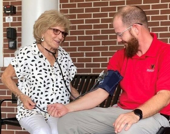 Jane Dekle, who retired as a nurse at First Baptist Church in Statesboro two years ago, checks church staffer Bryan Creasy's blood pressure in this file photo from 2021. Barna Research Group says a day of rest is crucial for the spiritual, emotional and physical wellbeing of ministers. (Index/Roger Alford)