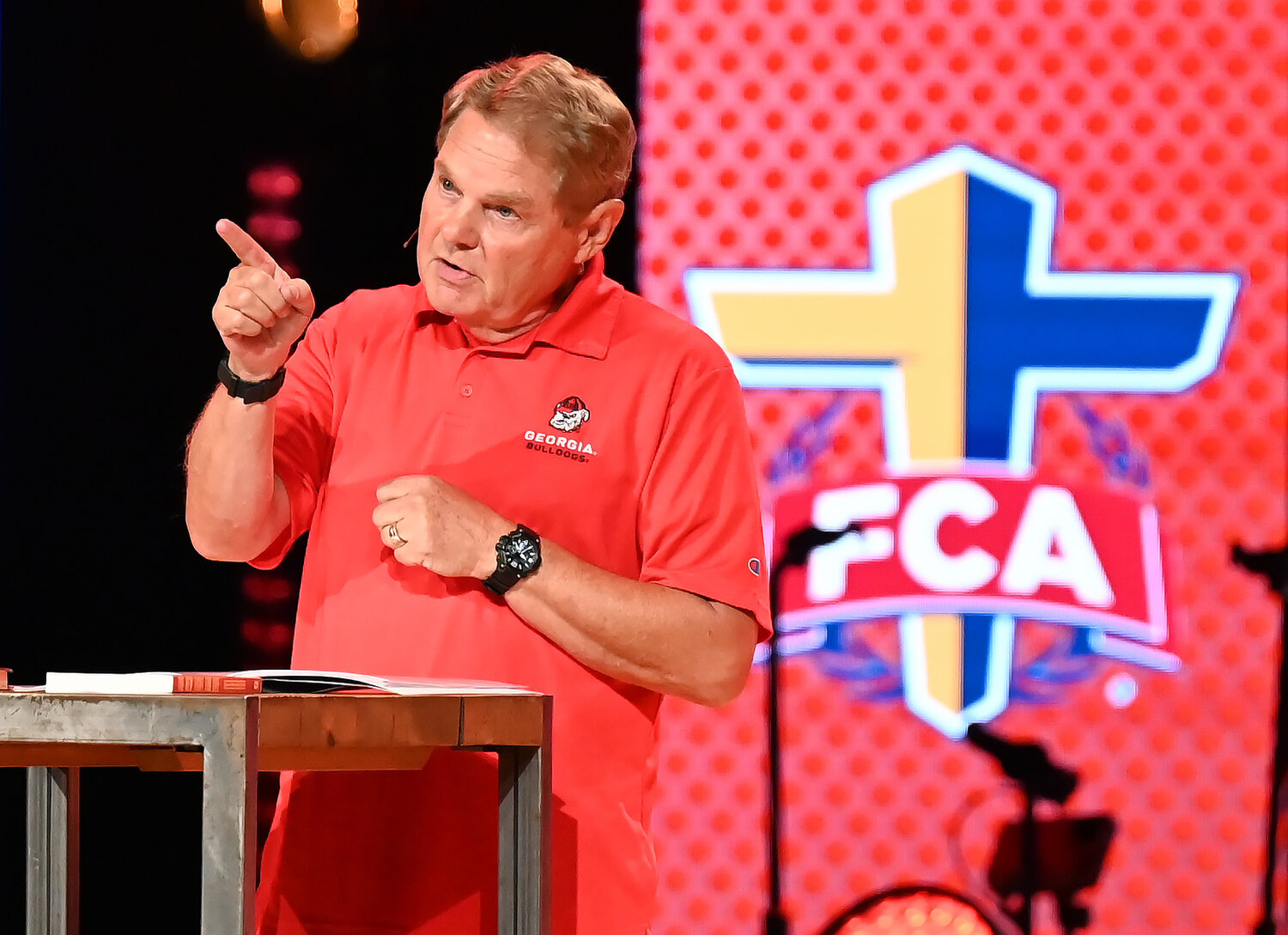 Bob Reccord, emcee for the Fellowship of Christian Athletes UGA Night of Champions event at First Baptist Church of Woodstock, presents the gospel Friday. (Index/Henry Durand)