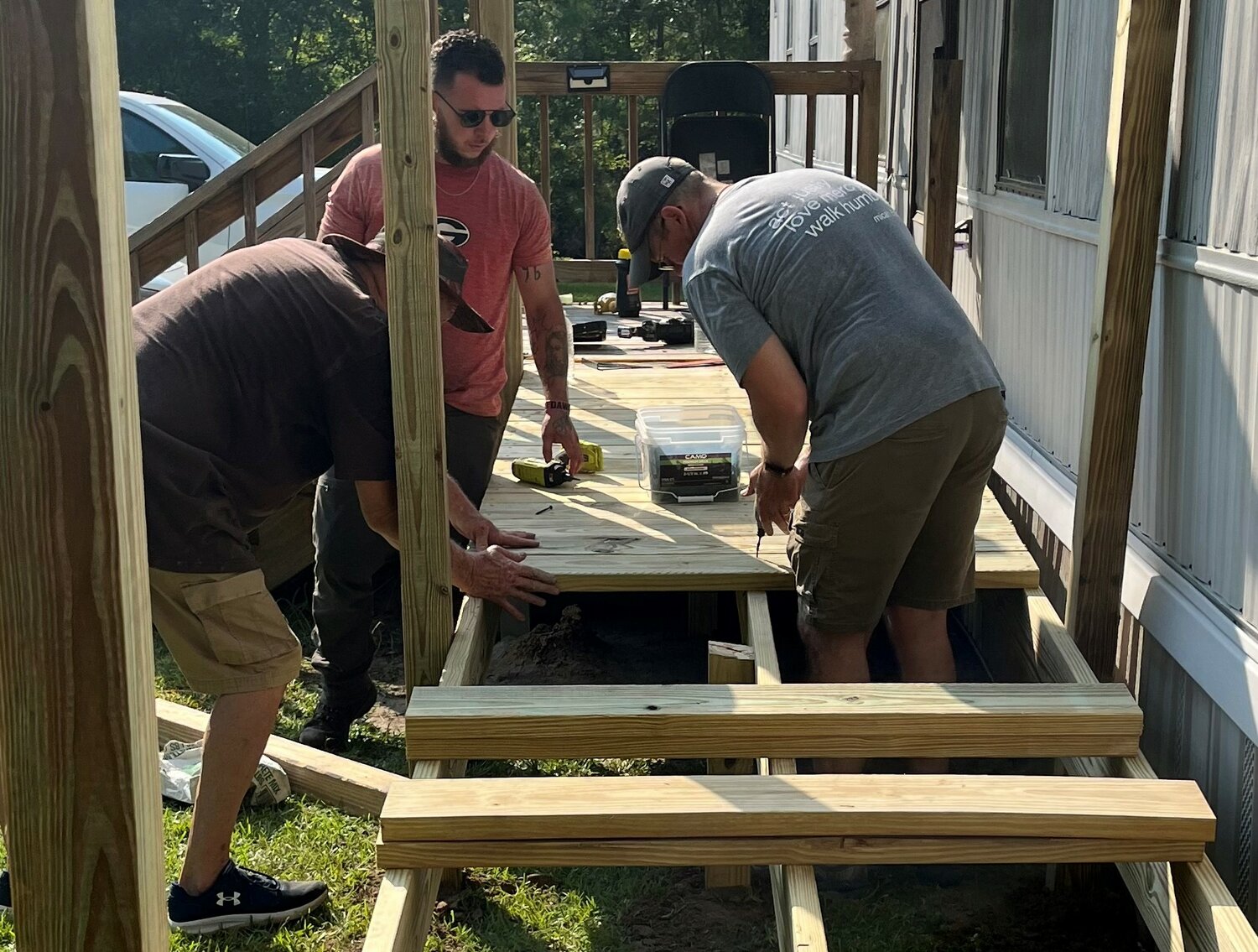 Ricky Wilkerson, left, Joseph Poole, center, and Jason Jones work on a wheelchair ramp at a home in Sylvester, Ga. (Photo/Isabella Baptist Church)