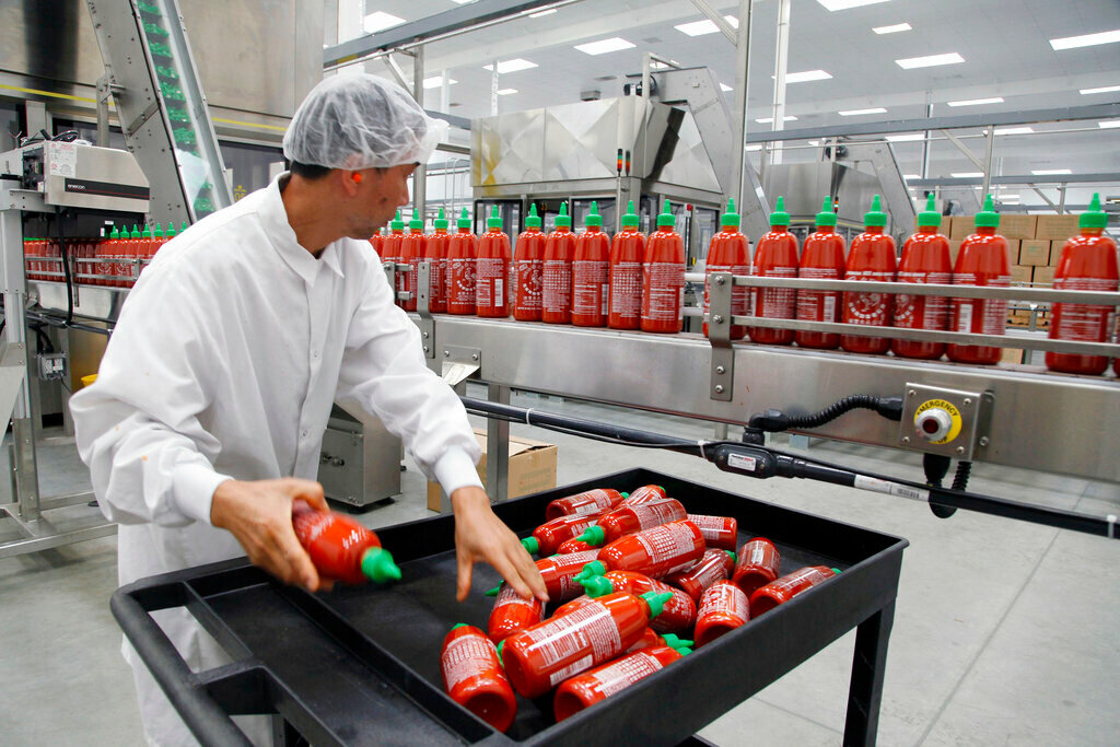 Sriracha chili sauce is produced at the Huy Fong Foods factory in Irwindale, Calif., in October 2013. (AP Photo/Nick Ut, File)