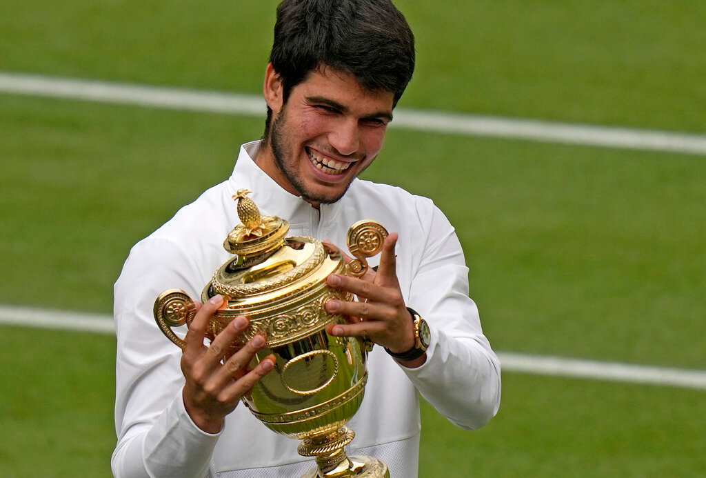 Spain's Carlos Alcaraz celebrates with the trophy after beating Serbia's Novak Djokovic to win the final of the Wimbledon men's singles in London, Sunday, July 16, 2023. (AP Photo/Alastair Grant)