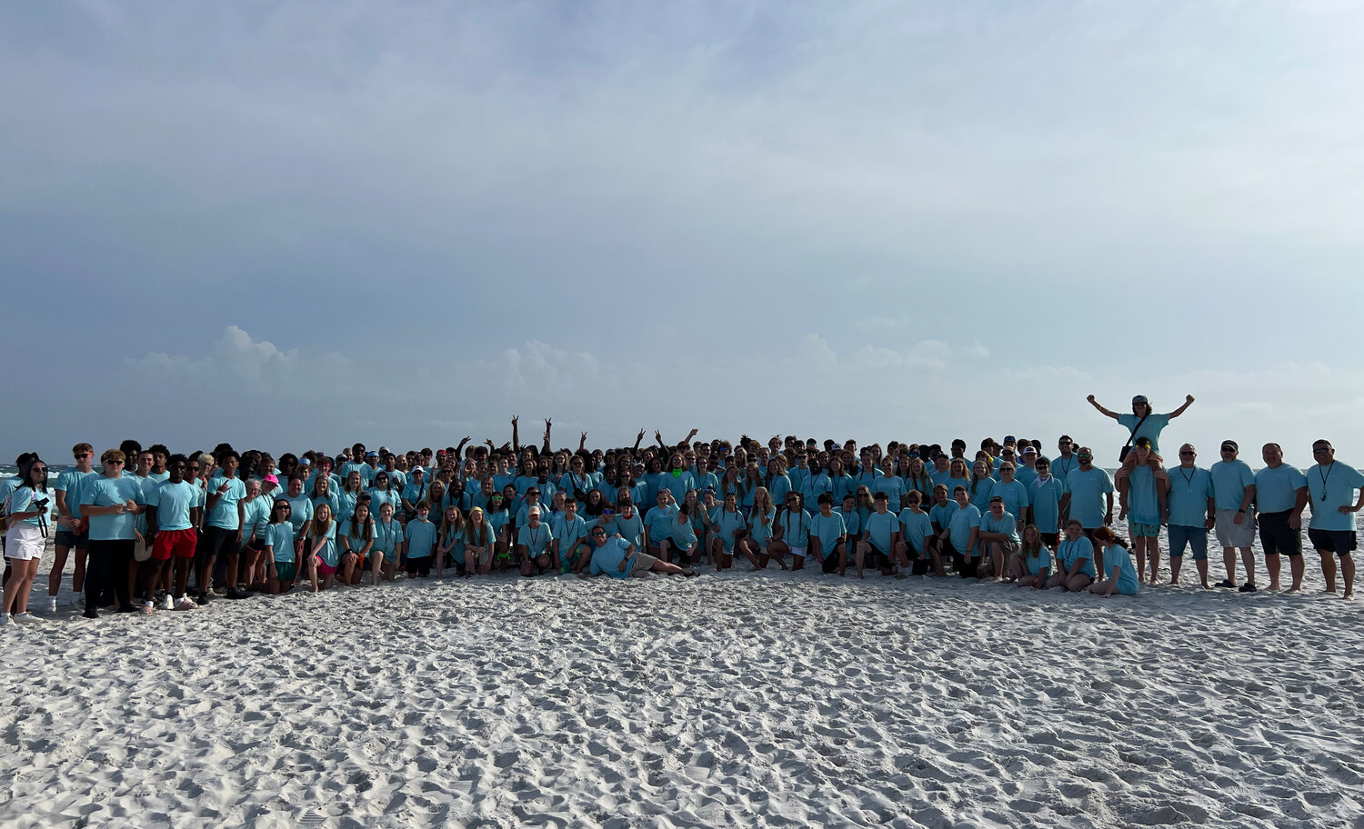 Students and football players gather for a group photo at First Baptist Church Villa Rica’s beach retreat.