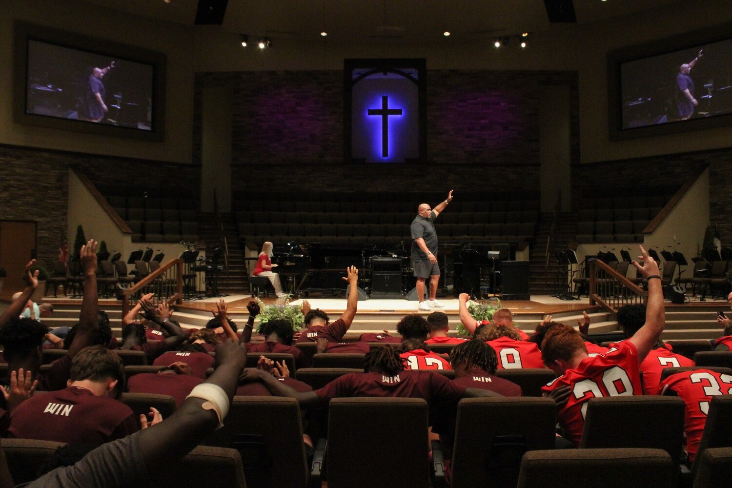 Former NFL player David Rocker shares the gospel at Roopville Road Baptist Church during Gridiron Day