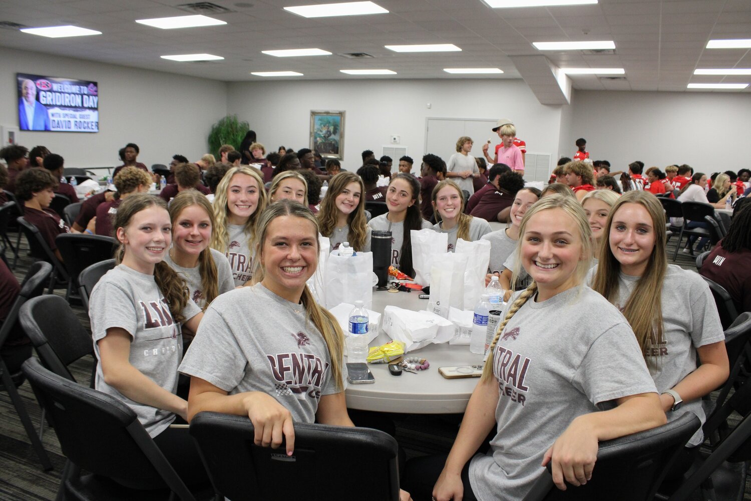 Cheerleaders pose for a photo during dinner at Roopville Road's Gridiron Day on Thursday, Aug. 10, 2023.