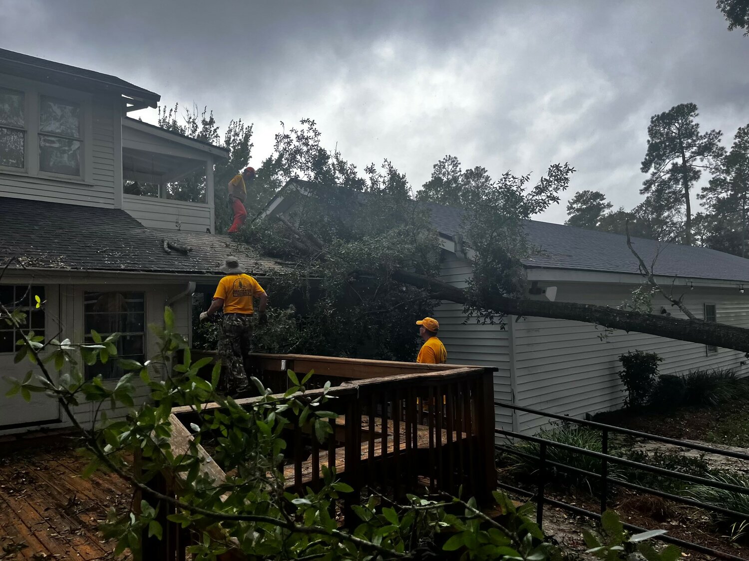 A chainsaw crew from Georgia Baptist Disaster Remove a tree from Baptist Collegiate Ministries building at Valdosta State University. (Photo/David Williams)