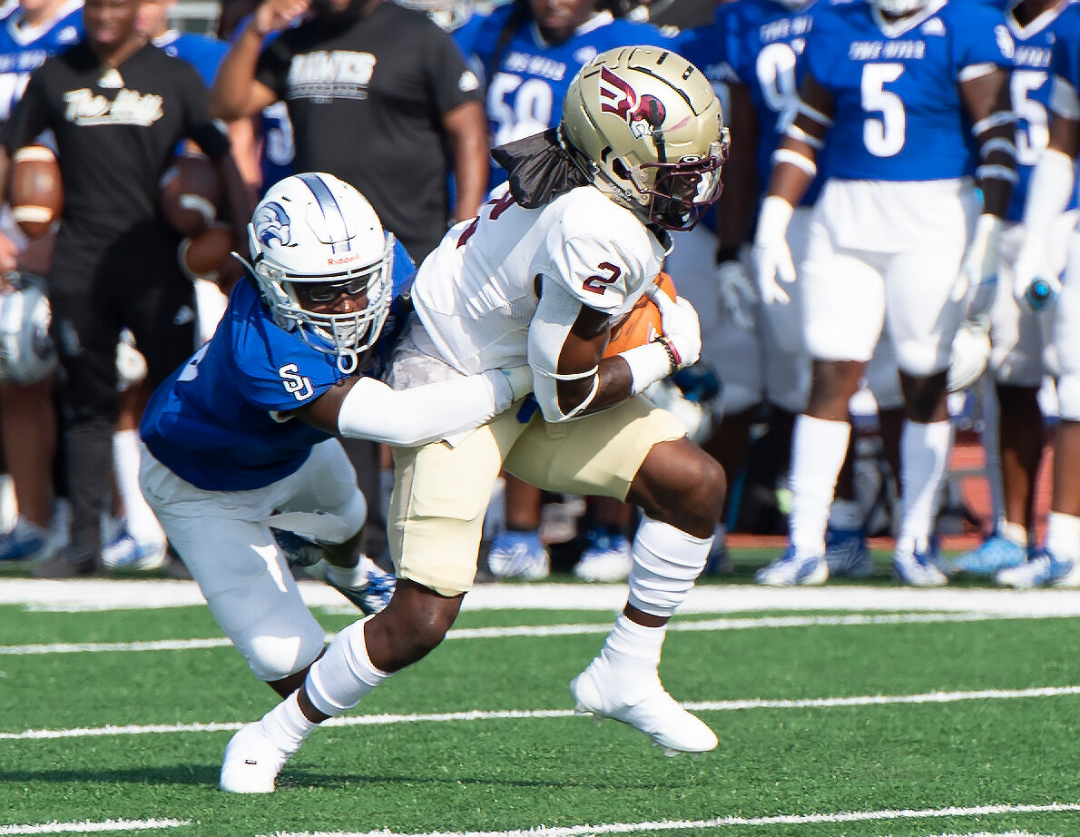 Shorter University's defensive back Milton Adams pulls down Erskine College running back Kaavan Parker (2) in the open field during the third quarter Saturday, Sept. 9, 2023, in Rome, Ga. Shorter won 28-7. (Index/Henry Durand)