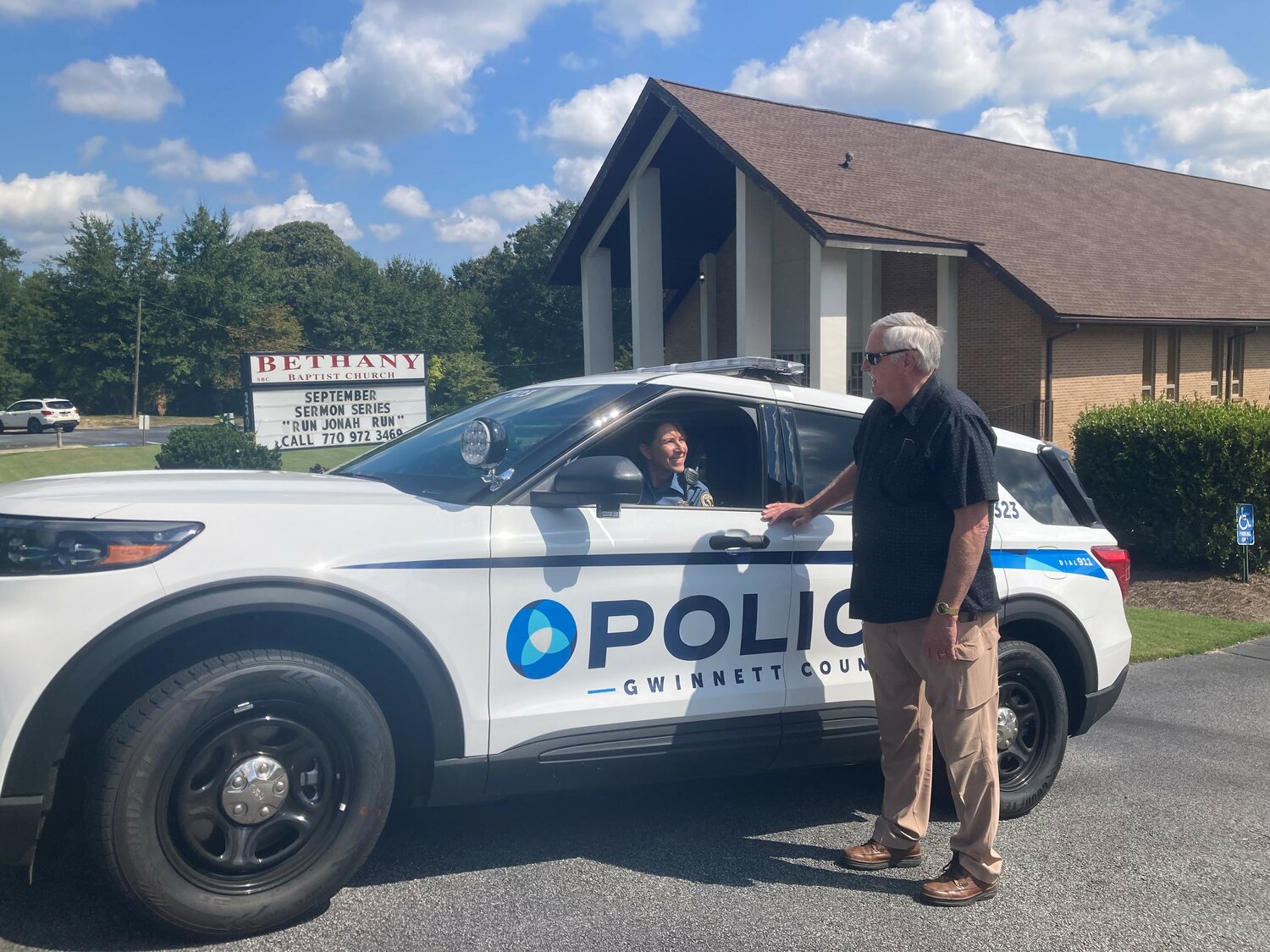 Bethany Baptist Church Executive Pastor Rick Kirkland, right, talks with Sgt. Michele Pihera outside the church in Snellville, Ga., on Monday, September 11, 2023. (Index/Roger Alford