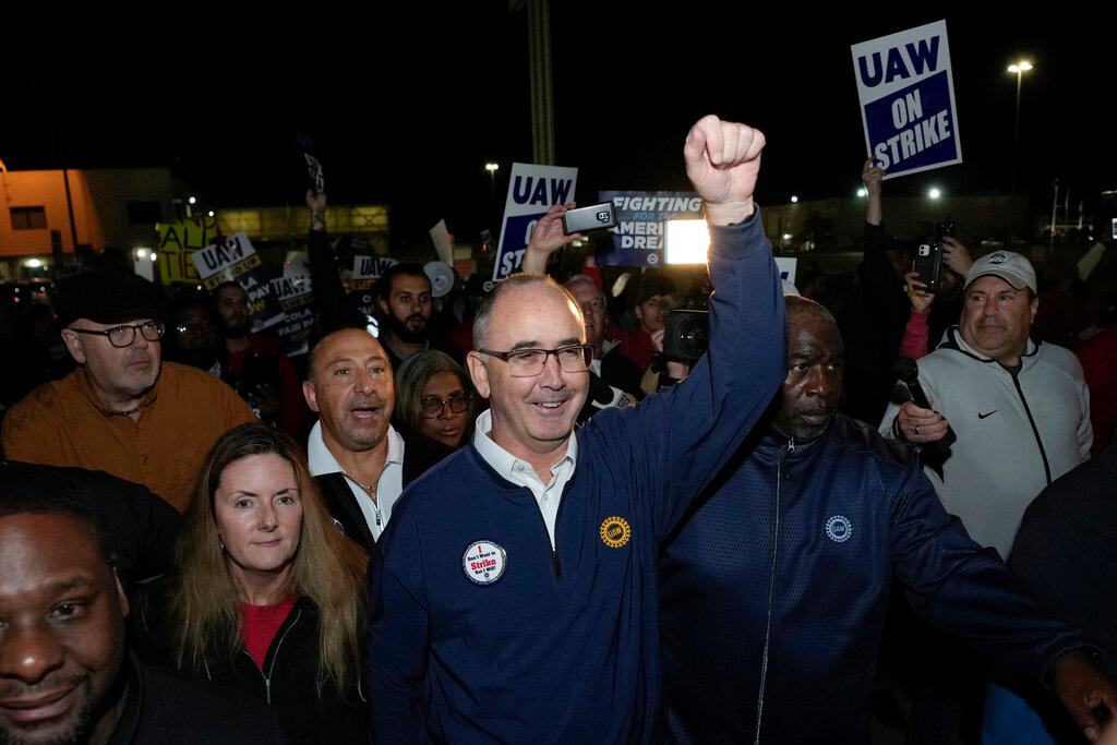 United Auto Workers President Shawn Fain walks with union members striking at Ford's Michigan Assembly Plant in Wayne, Mich., early Friday, Sept. 15, 2023. (AP Photo/Paul Sancya)