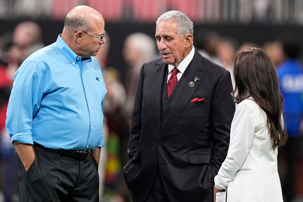 Carolina Panthers Owner David Tepper, left, and Atlanta Falcons Owner Arthur Blank speak before the first half of an NFL game Sunday, Sept. 10, 2023, in Atlanta. (AP Photo/Brynn Anderson)
