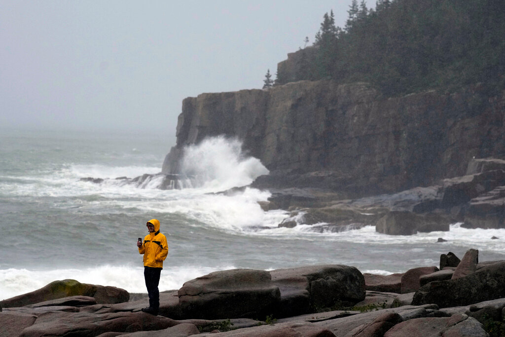 Chris Crawford, of Mount Desert Island, Maine, films the raging surf near Otter Point in Acadia National Park as severe weather associated with storm Lee pounds the region, Saturday, Sept. 16, 2023, in Bar Harbor, Maine. (AP Photo/Robert F. Bukaty)