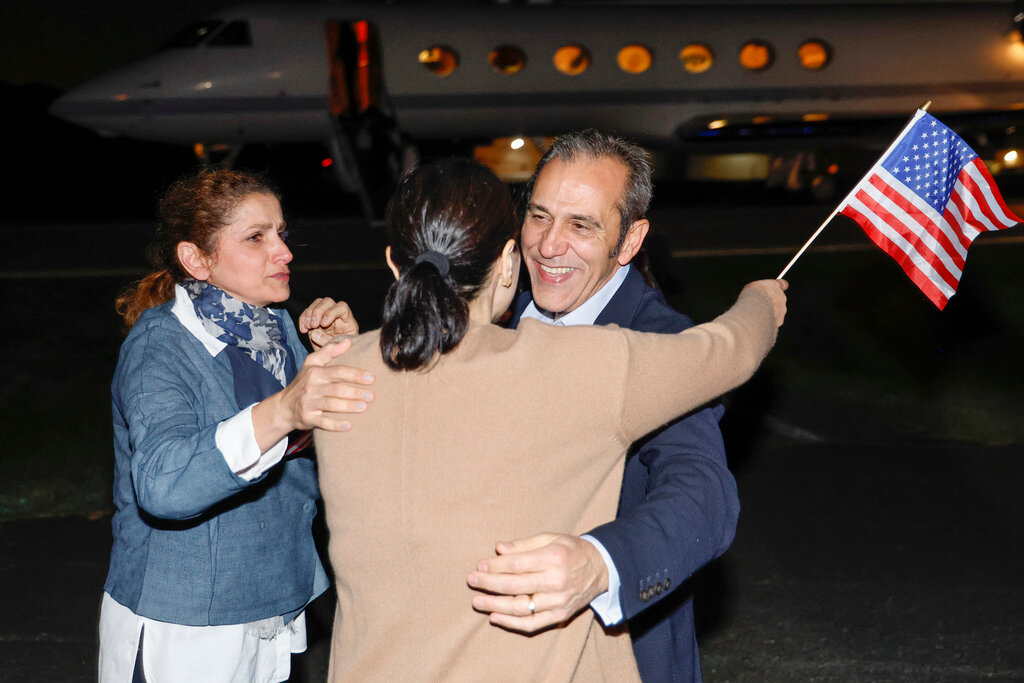 Family members embrace freed American Emad Shargi after he and four fellow detainees were released in a prisoner swap deal between U.S and Iran, Tuesday, Sept. 19, 2023 at Fort Belvoir, Va. (Jonathan Ernst/Pool via AP)