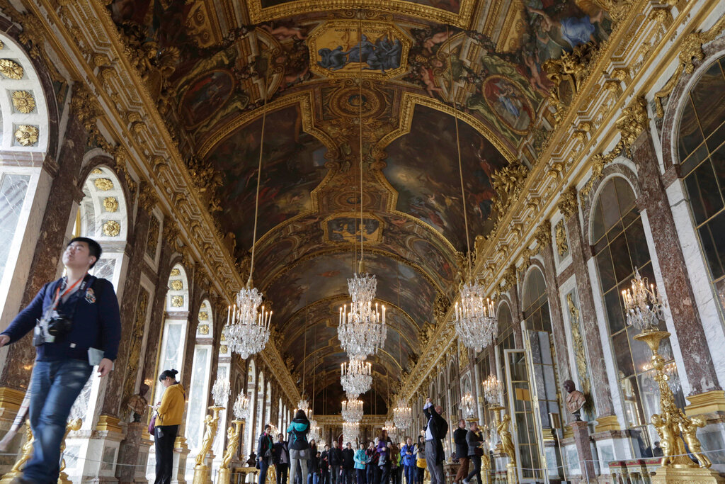 Visitors walk inside the Hall of Mirrors in the Versailles castle, on Nov. 17, 2015 in Versailles, west of Paris. (AP Photo/Amr Nabil, File)
