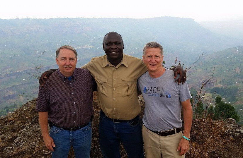 Mike Emeott, Uganda Pastor Fred Mazune and Warren Moore, from left, stand on the slopes of the mountains surrounding Kapchorwa, Uganda.