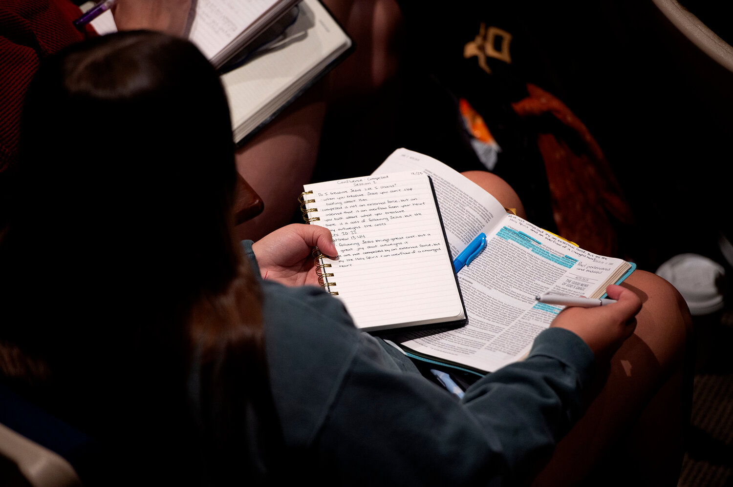A student takes notes during Tom Richter's message at Confluence 2023 at Eagle's Landing First Baptist Church in McDonough, Ga., Saturday, Sept. 23, 2023. (Index/Henry Durand)