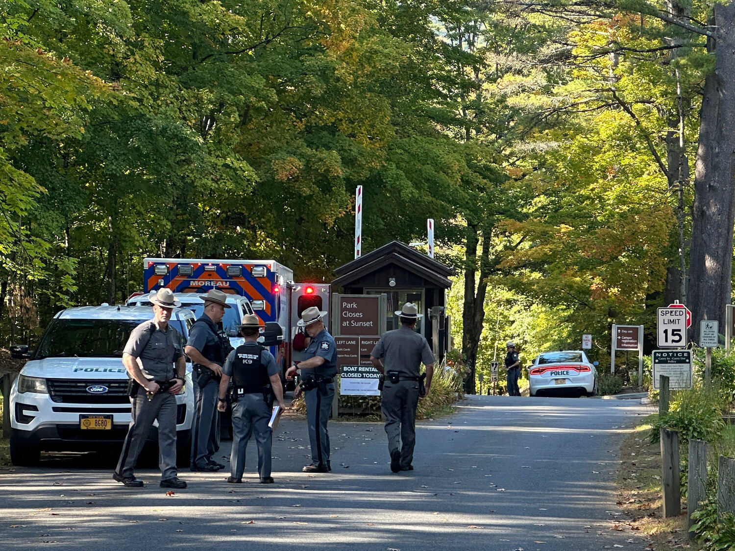 Police secure the entrance to Moreau Lake State Park as they search for Charlotte Sena, a missing 9-year-old girl who had been camping over the weekend with her family at the park, Monday Oct. 2, 2023, in New York. The girl was found safe Monday following a two-day search, authorities said. (AP Photo/Michael Hill)