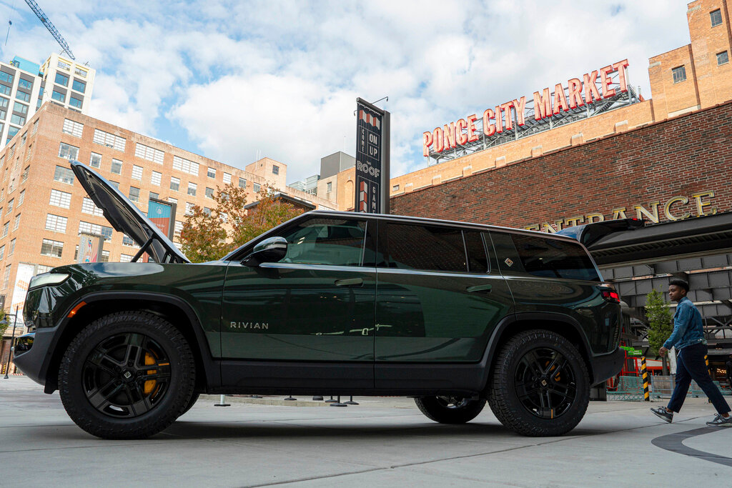 A Rivian R1S is displayed outside of the auto manufacturer's new space at Ponce City Market on Thursday, Oct. 19, 2023 in Atlanta. Rivian Automotive will move ahead with construction on a factory in Georgia early next year, the company confirmed Thursday. (Matthew Pearson/WABE via AP)