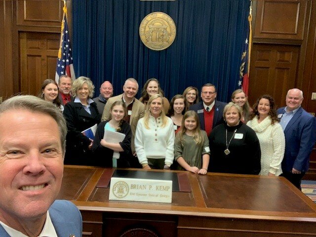 Georgia Gov. Brian Kemp takes a selfie with a group touring the Georgia Capitol on Dec. 19, 2022, in his office. (Photo/Brian Kemp)