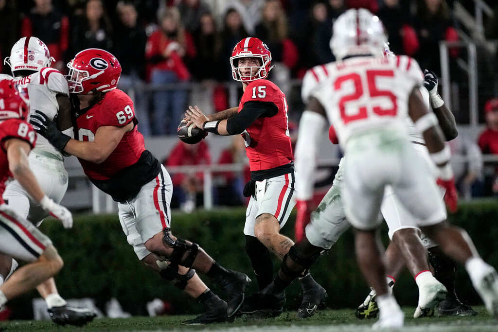 Georgia quarterback Carson Beck (15) throws from the pocket during the first half of an NCAA college football game against Mississippi, Saturday, Nov. 11, 2023, in Athens, Ga. (AP Photo/John Bazemore)