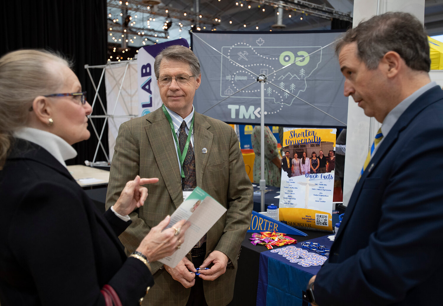 Dr. Donald Dowless, president of Shorter University, and Provost John Reams, right, speak with a messenger at the school's booth in the vendor area during the third day of the Georgia Baptist Convention's 201st annual meeting Tuesday at Church on Main in Snellville, Ga. (Index/Henry Durand)