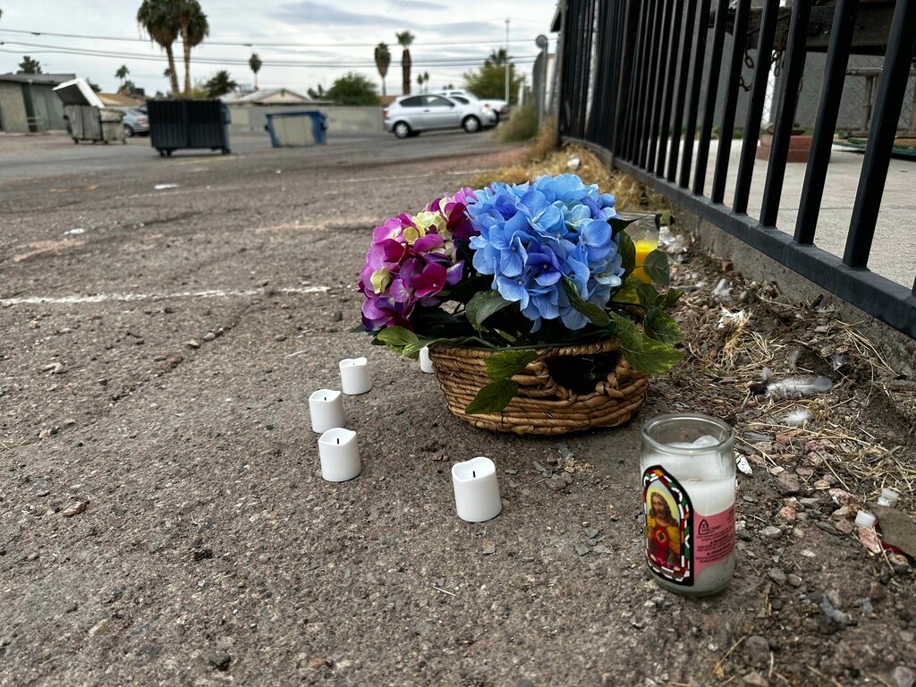 A makeshift memorial for a high school student lines a fence along an alleyway near Rancho High School in eastern Las Vegas on Wednesday, Nov. 15, 2023. (AP Photo/Rio Yamat)
