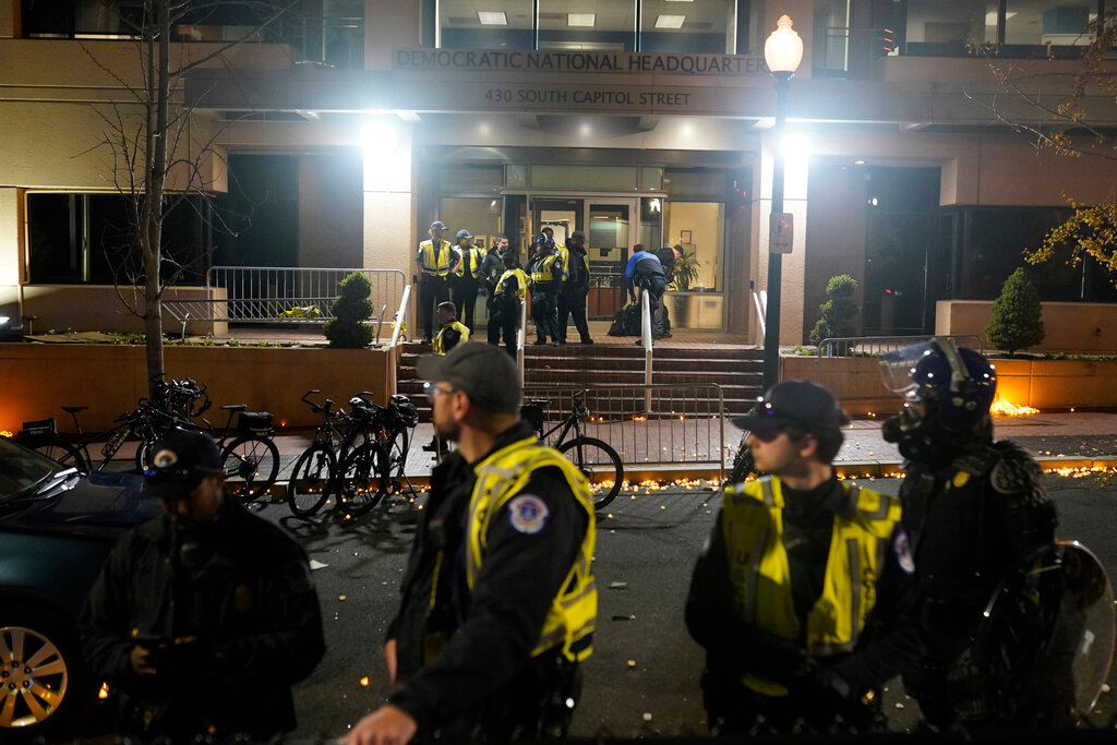 U.S. Capitol Police stand outside the headquarters of the Democratic National Committee Wednesday, Nov. 15, 2023, in Washington.  (AP Photo/Nathan Howard)