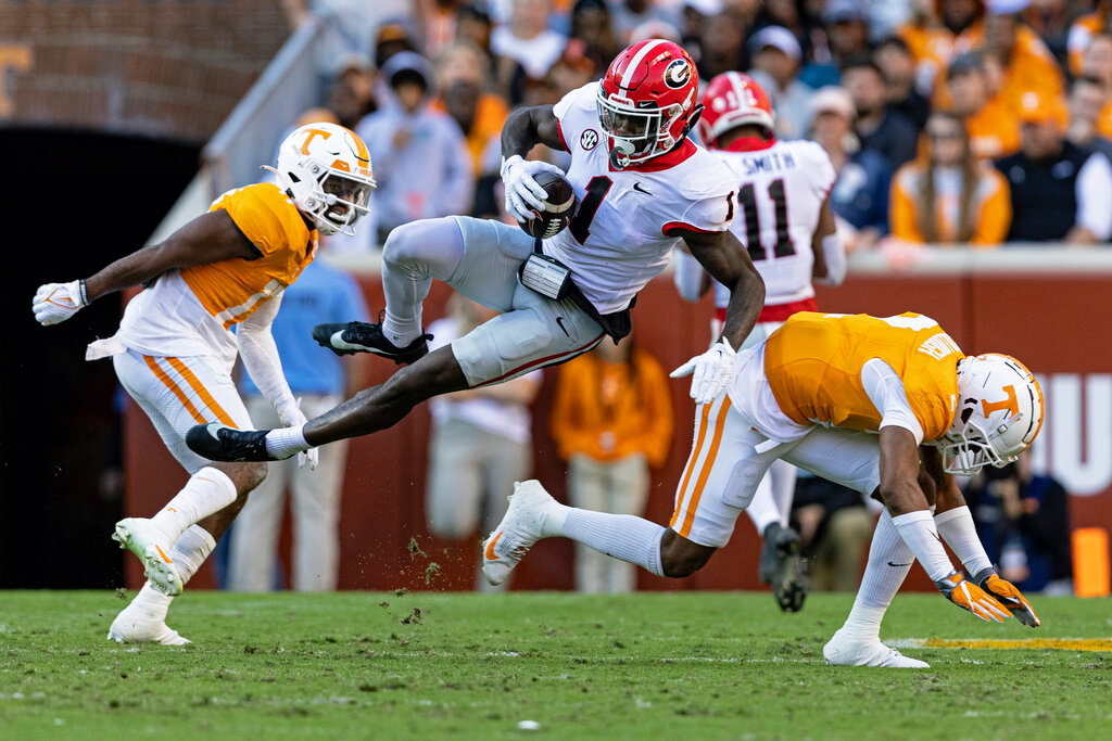 Georgia wide receiver Marcus Rosemy-Jacksaint (1) is knocked off his feet by Tennessee defensive back Jaylen McCollough (2) during the first half of an NCAA college football game Saturday, Nov. 18, 2023, in Knoxville, Tenn. (AP Photo/Wade Payne)