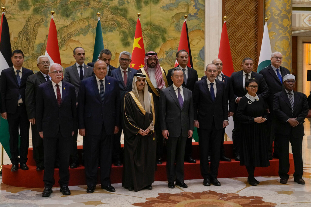 Chinese Foreign Minister Wang Yi, foreground center, stands with his counterparts, from left, Palestine Foreign Minister Riyad al-Maliki, Egyptian Foreign Minister Sameh Shoukry, Saudi Arabia's Foreign Minister Faisal bin Farhan Al Saud, Jordanian Deputy Prime Minister and Foreign Minister Ayman Safadi, Indonesian Foreign Minister Retno Marsudi, Secretary-General of the Organization of Islamic Cooperation (OIC) Hissein Brahim Taha and their delegations prior to their meeting in Beijing, Monday, Nov. 20, 2023. (AP Photo/Andy Wong)