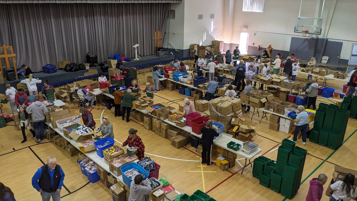 Volunteers from Welcome Hill Baptist Church, part of the Conasauga Baptist Association, gather in their Multi-Ministry Building and form assembly lines to pack shoeboxes for Operation Christmas Child. (Photo/Welcome Hill Baptist Church)