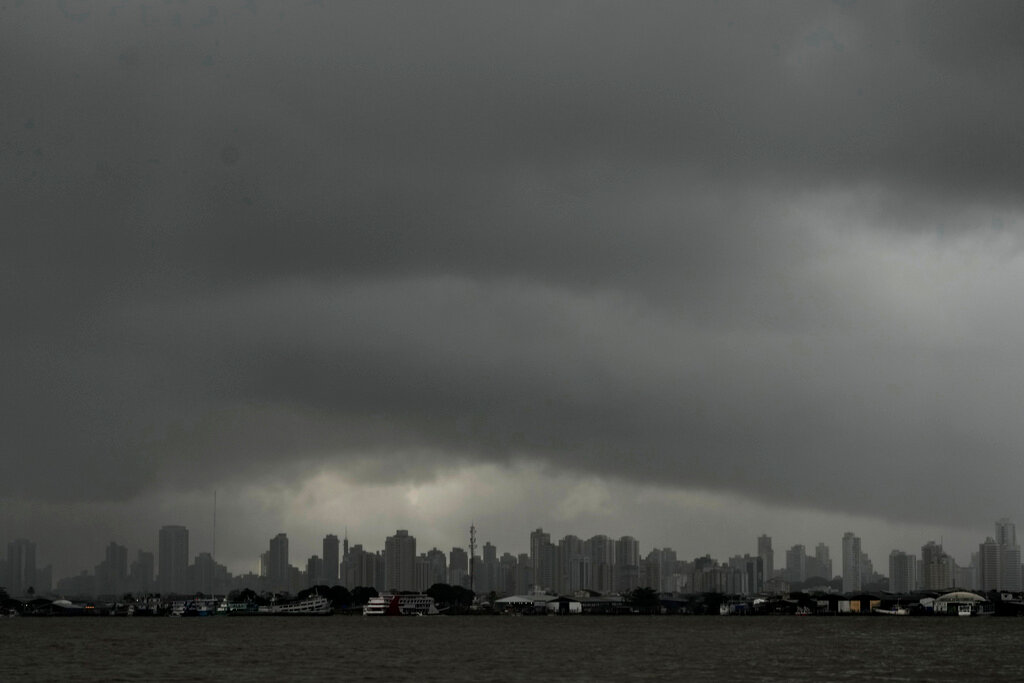 Rain-heavy clouds hover above the city of Belem, seen from Ilha do Combu, Para state, Brazil, Saturday, May 27, 2023. (AP Photo/Eraldo Peres)