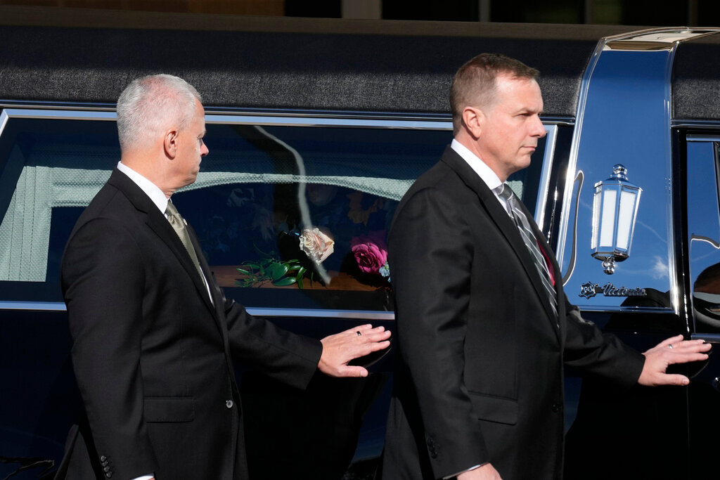 Former and current U.S. Secret Service agents assigned to the Carter detail, walk next to the hearse carrying the casket of former first lady Rosalynn Carter at Phoebe Sumter Medical Center in Americus, Ga., Monday, Nov. 27, 2023. (AP Photo/Alex Brandon, Pool)