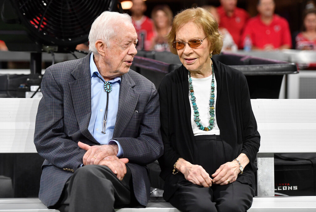 Former President Jimmy Carter and Rosalynn Carter are seen ahead of a game between the Atlanta Falcons and the Cincinnati Bengals in Atlanta, Sept. 30, 2018. (AP Photo/John Amis, File)