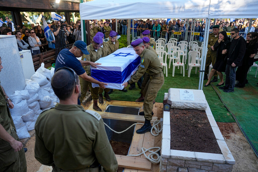 Israeli soldiers carry a flagged coffin during a memorial service for Sergeant Kiril Brodski in the Kiryat Shaul military cemetery in Tel Aviv, Wednesday, Nov. 29, 2023. Brodski and two other soldiers, believed to have been among those killed in the initial Oct. 7 Hamas attack, were declared dead by the military Tuesday, with their remains still in Gaza. (AP Photo/Ariel Schalit)