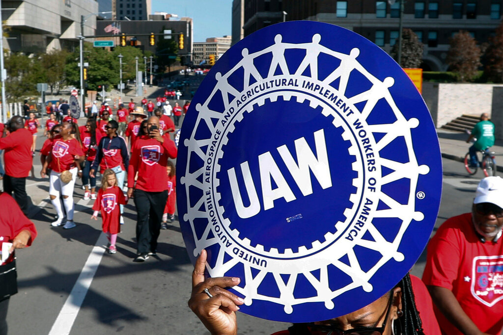 United Auto Workers members walk in the Labor Day parade, Sept. 2, 2019, in Detroit. (AP Photo/Paul Sancya, File)