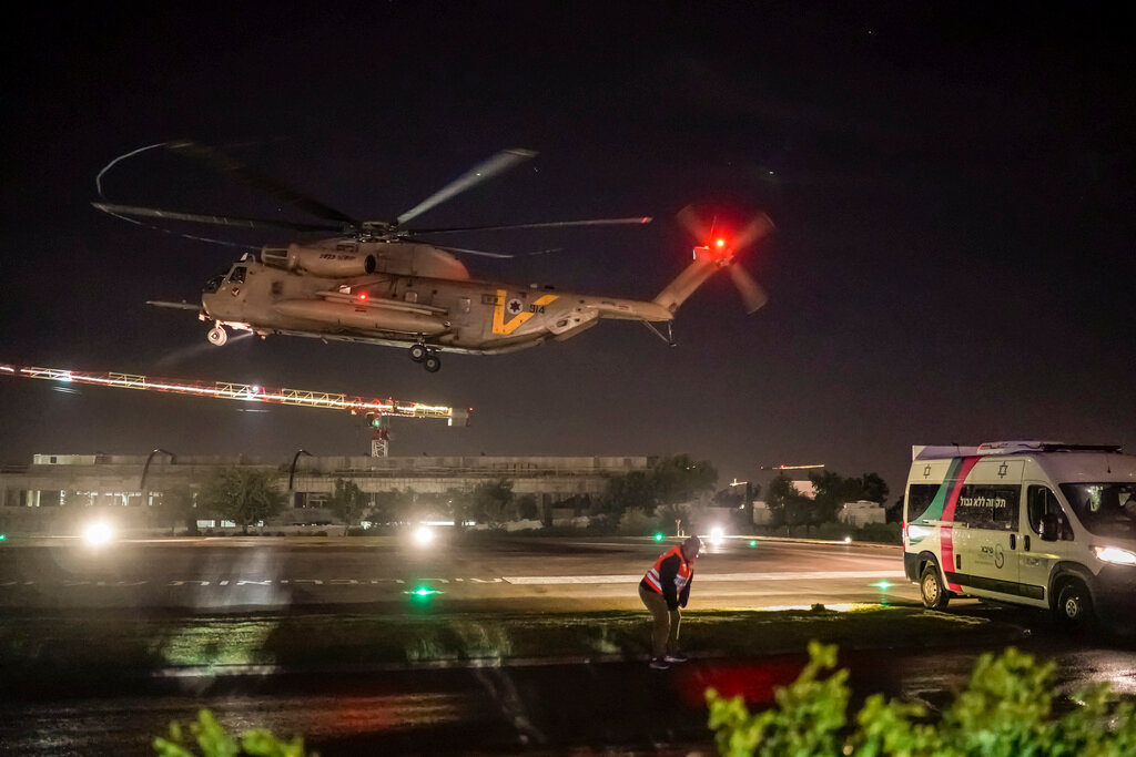 A helicopter carrying Israeli hostages released by Hamas lands at the Sheba Medical Center in Ramat Gan, Israel, early Thursday, Nov. 30, 2023. (AP Photo/Leo Correa)