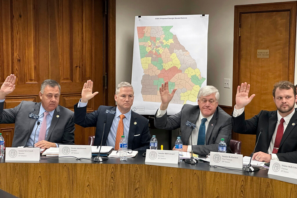Four Republican Georgia state Sens., from left, Steve Gooch, John Kennedy, Bill Cowsert and Bo Hatchett vote in favor of their party's plan to draw new voting districts for the state Senate, Thursday, Nov. 30, 2023, at the Georgia Capitol in Atlanta. (AP Photo/Jeff Amy)