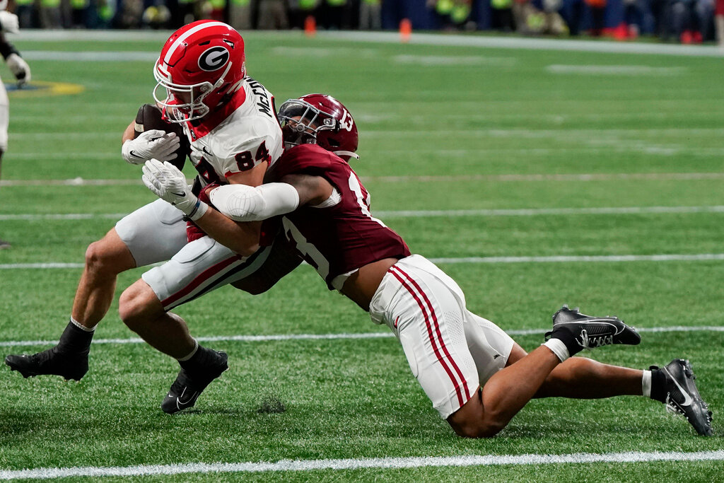 Alabama defensive back Malachi Moore tackles Georgia wide receiver Ladd McConkey (84) after a reception in the second half of the Southeastern Conference championship game in Atlanta, Saturday, Dec. 2, 2023. (AP Photo/Mike Stewart)