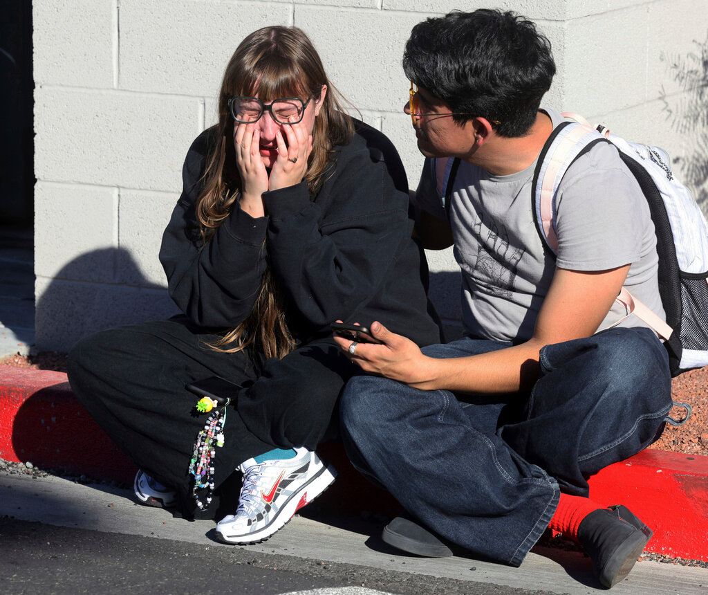 Amanda Perez, left, is comforted by fellow student Alejandro Barron following a shooting on the University of Nevada, Las Vegas, campus, Wednesday, Dec. 6, 2023, in Las Vegas. (K.M. Cannon/Las Vegas Review-Journal via AP)