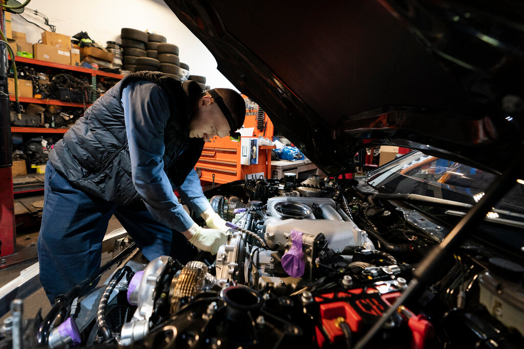 Mechanic David Stoliaruk works on the engine of a car at IC Auto in Philadelphia, May 2, 2023. (AP Photo/Matt Rourke, File)