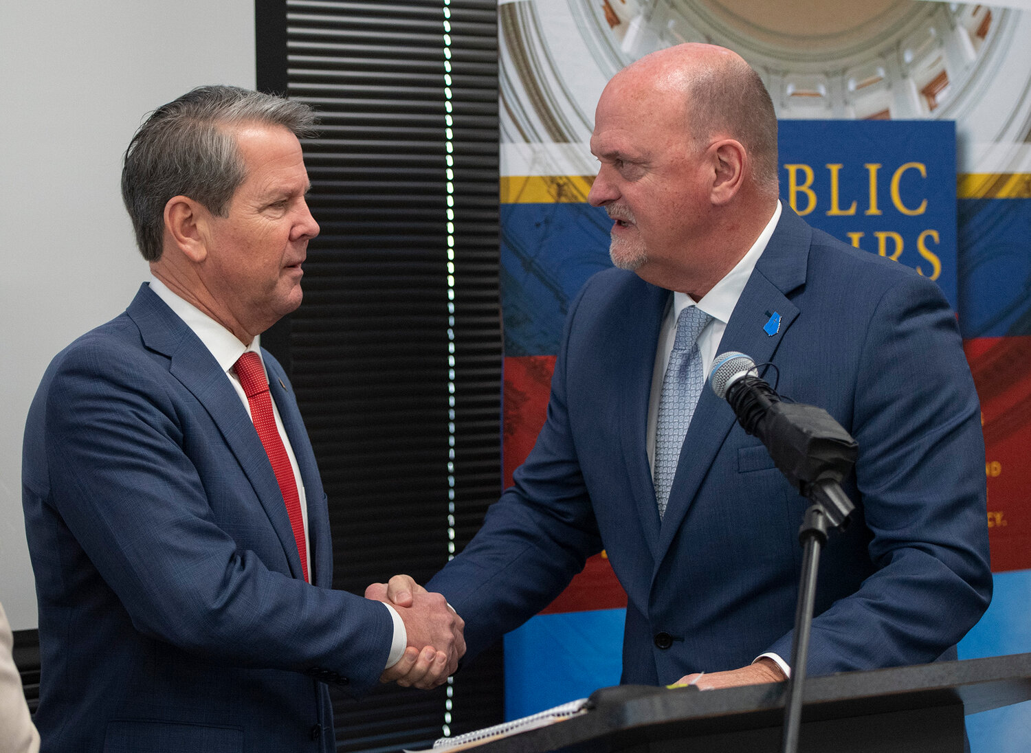 Georgia Gov. Brian Kemp, left, and W. Thomas Hammond Jr., talk at an event at the state Capitol on Tuesday, Feb. 6, 2024. (Index/Henry Durand)
