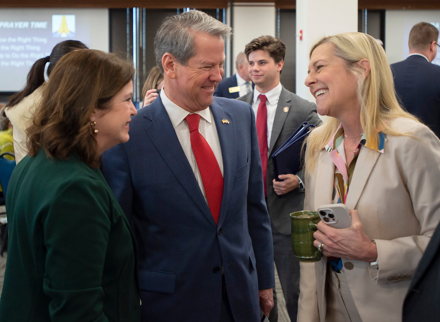 Georgia Gov. Brian Kemp and his wife Marty, right, laugh with Julie Scott Emmons of the Human Coalition during a Georgia Baptist Mission Board event at the state Capitol on Tuesday, Feb. 6, 2024. (Index/Henry Durand)