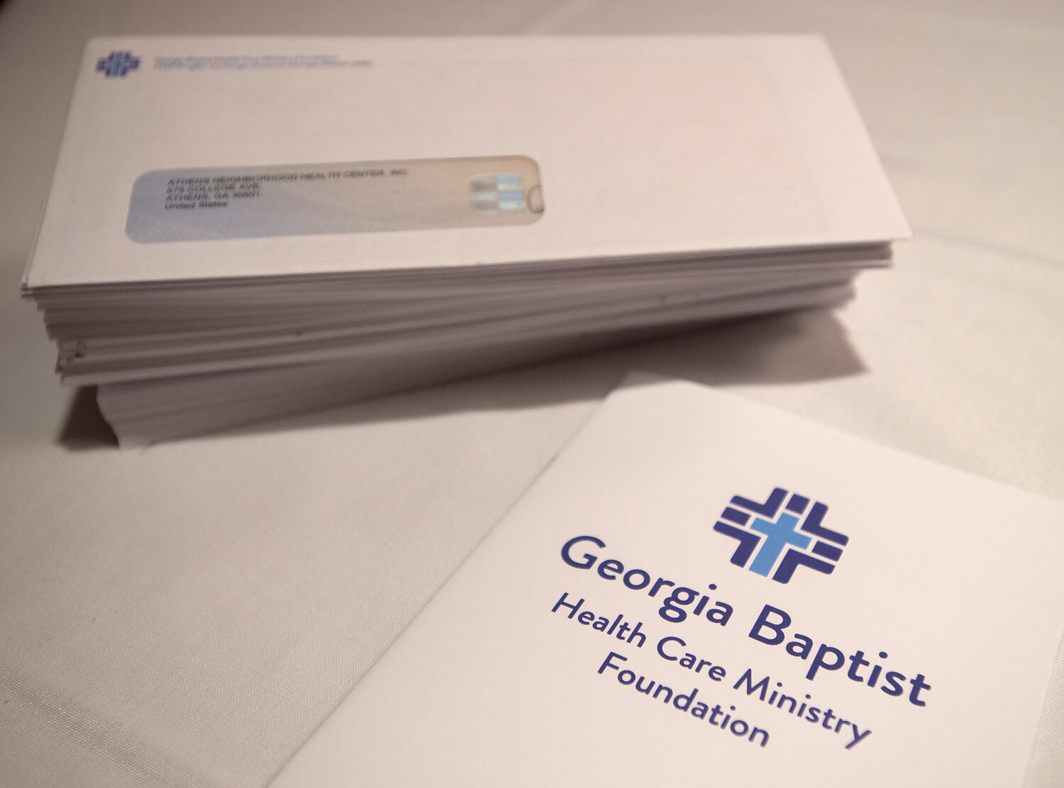 A stack of checks ready to be given to Georgia Baptist Health Care Ministry Foundation grant recipients at a luncheon on Thursday, Feb. 8, 2024. (Index/Henry Durand)