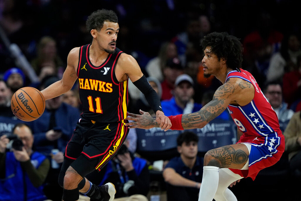 Atlanta Hawks' Trae Young, left, tries to get past Philadelphia 76ers' Kelly Oubre Jr. during the second half of an NBA basketball game, Friday, Feb. 9, 2024, in Philadelphia. (AP Photo/Matt Slocum)