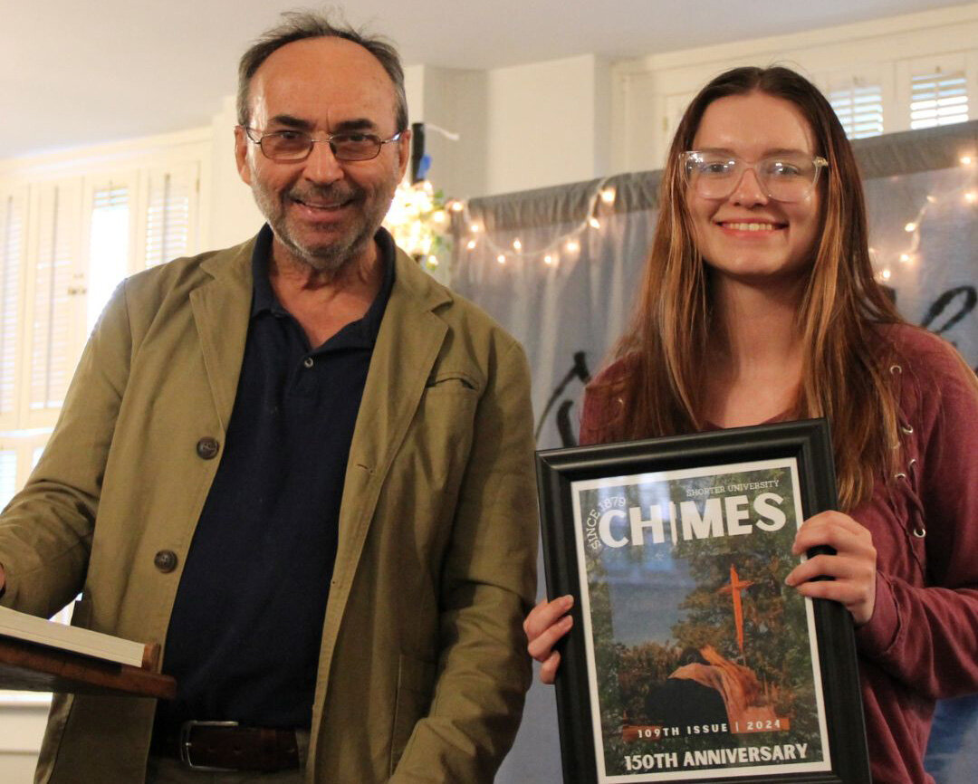 Dr. Fabrice Poussin, Shorter University professor and faculty advisor for Chimes, and fiction editor Alicyn Harris display an award at the magazine's release party. (Photo/Shorter University)