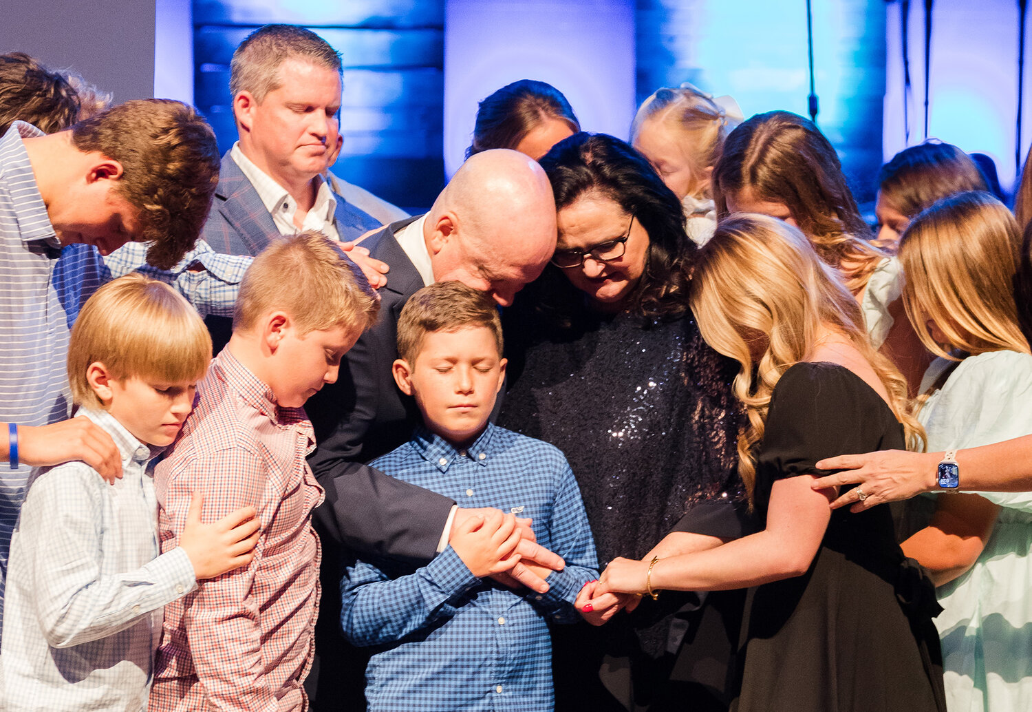 The Akin family prays during a celebration of the Akins' 20 years of service to Southeastern Seminary. (SEBTS/Rebessa Hankins)