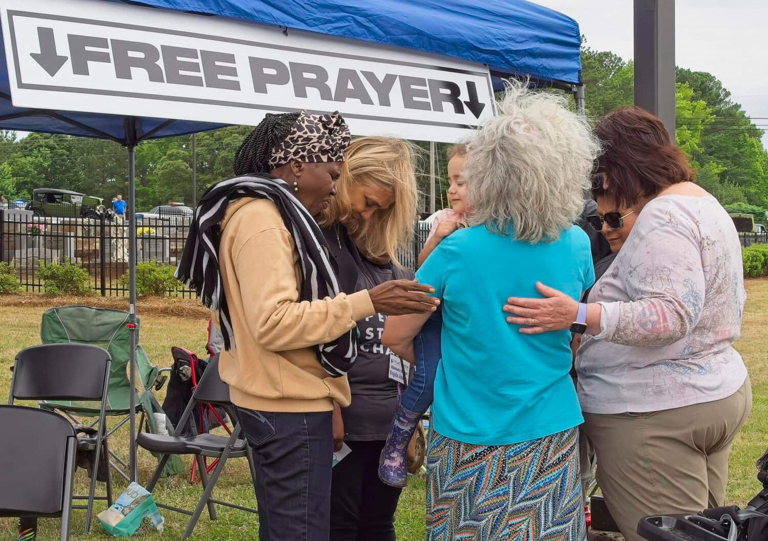 Women pray during the Cars and Crafts at the Creek 2024 event at Flat Creek Baptist Church in Fayetteville, Ga., on Saturday, June 1. (Photo/Flat Creek Bap0tist Church via Facebook)